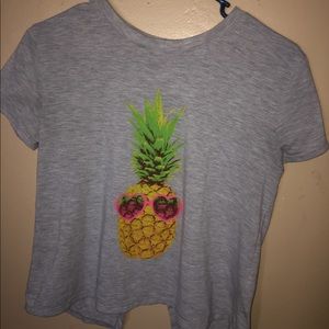 A gray shirt with a opening on the back